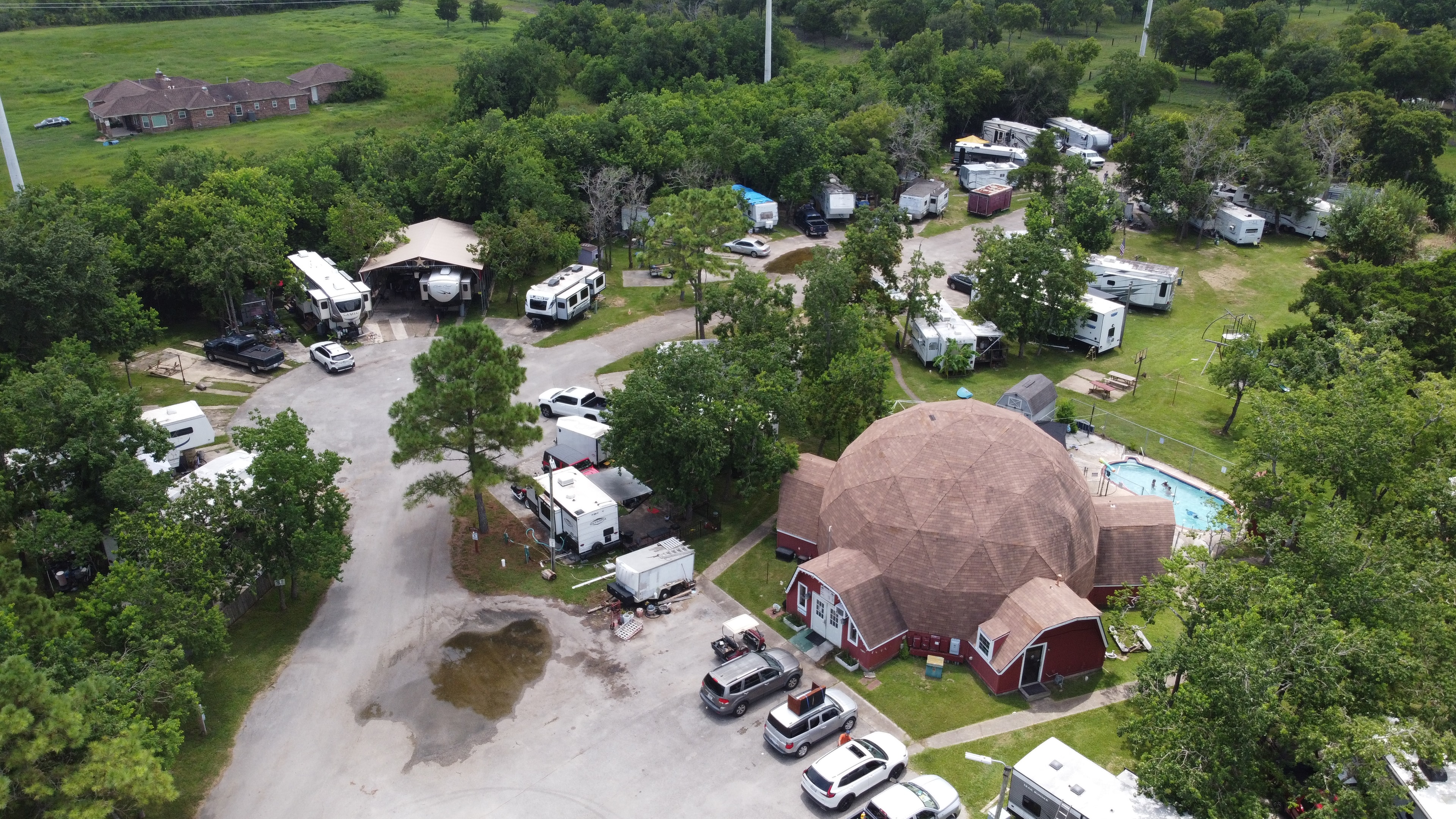 Drone photo of Little Thicket RV Resort showing dome building and pool
